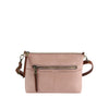 The Front Pocket Slim Crossbody Bag, in light pink faux leather, features a front zip pocket, top zip closure, and adjustable brown shoulder strap. Shown against a plain white background.