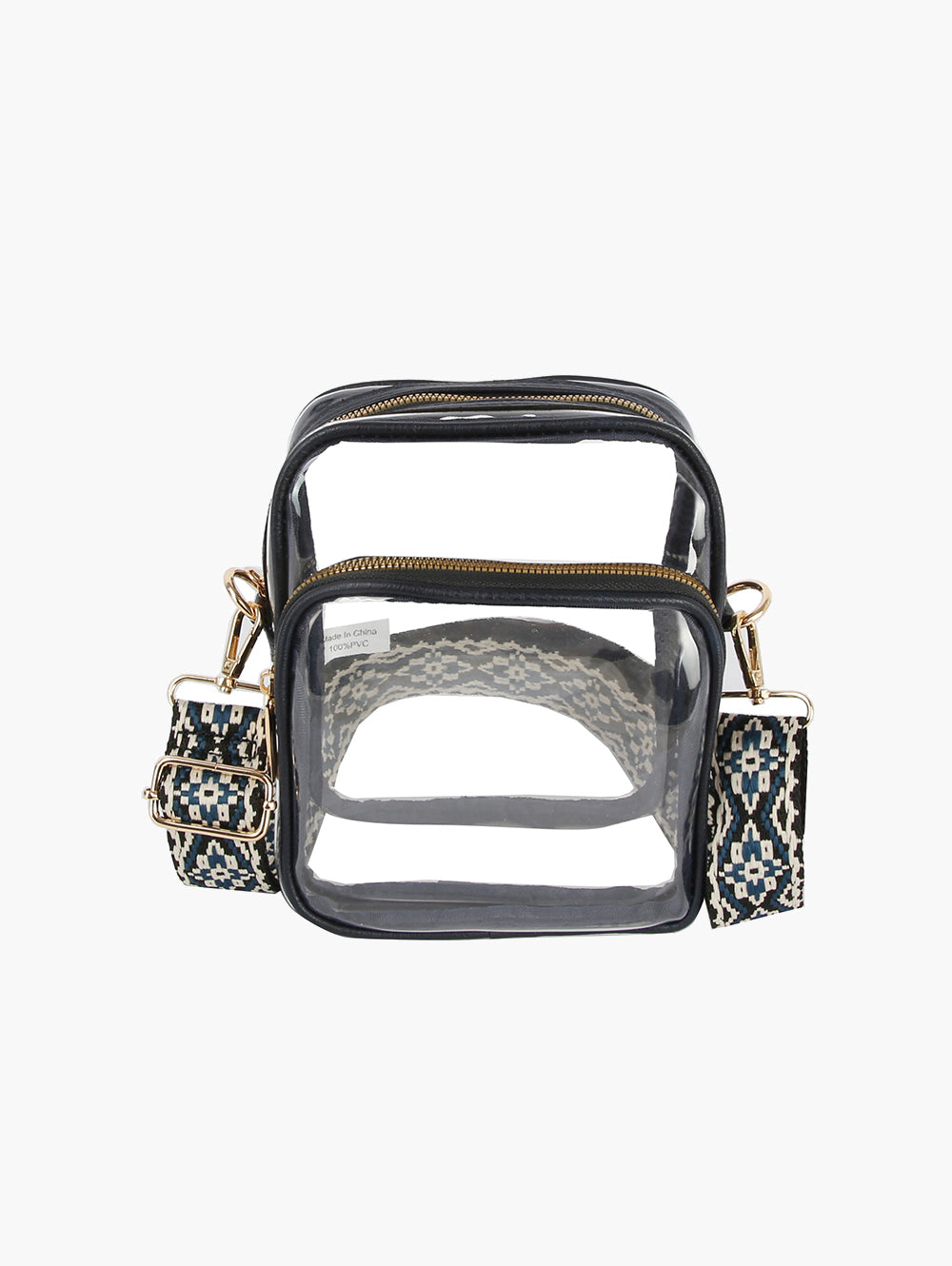 The Guitar Strap Clear Crossbody Bag is a rectangular zip-closure handbag with black trim, gold hardware, and a detachable blue and white geometric-patterned strap. Shown empty against a white background.