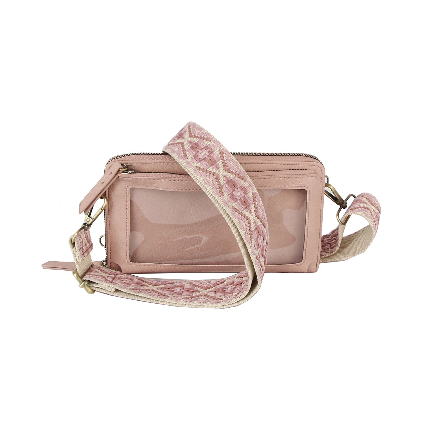 The Petite Multi Compartment Guitar Strap Crossbody is a small pink faux leather bag with a wide patterned detachable strap and a clear front pocket, shown against a white background.