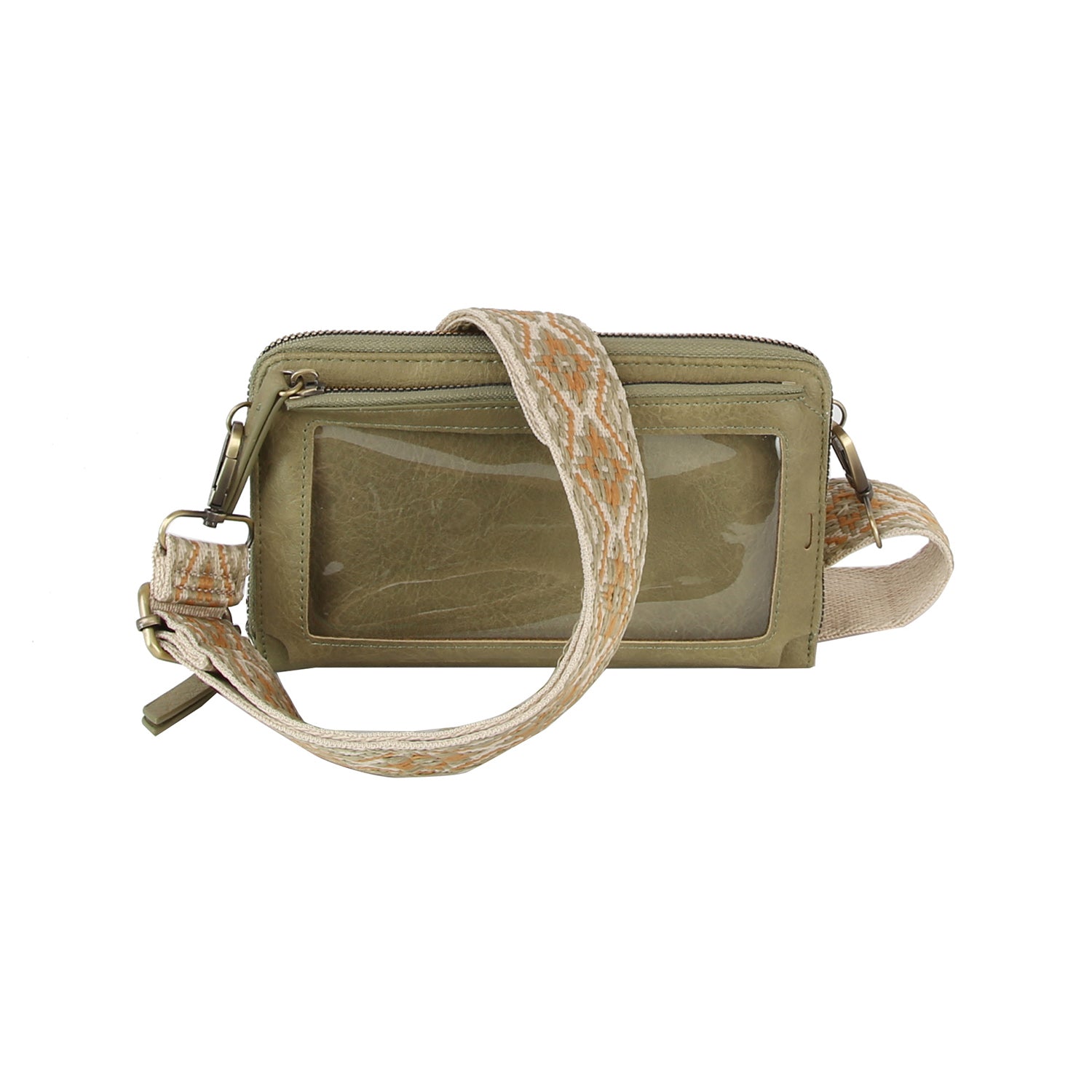 The Petite Multi Compartment Guitar Strap Crossbody is a small olive-green faux leather bag with a clear front pocket, zipper closure, and a wide beige strap accented by an orange geometric pattern.