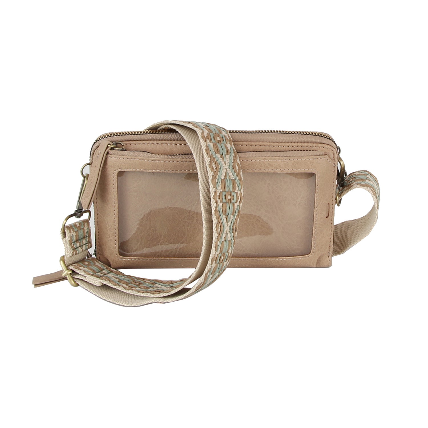 The Petite Multi Compartment Guitar Strap Crossbody is a small beige faux leather bag with a clear front pocket and wide, patterned adjustable strap, displayed against a white background.