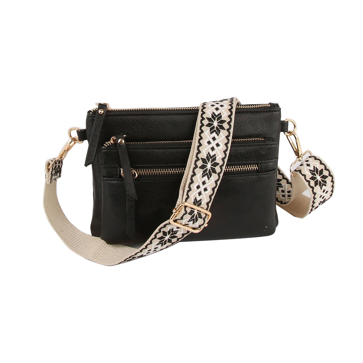 The Guitar Strap Crossbody Sling Handbag is a black faux leather bag with multiple zippered compartments and a wide cream strap featuring a black geometric floral pattern. It also includes a dual zip pocket for extra organization.