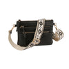 The Guitar Strap Crossbody Sling Handbag is a black faux leather bag with multiple zippered compartments and a wide cream strap featuring a black geometric floral pattern. It also includes a dual zip pocket for extra organization.