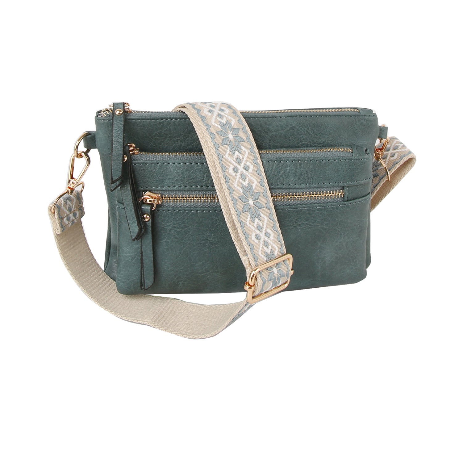 The Guitar Strap Crossbody Sling Handbag is a green faux leather bag with dual front zip pockets, gold-tone hardware, a textured finish, and a wide beige strap featuring a blue geometric pattern.