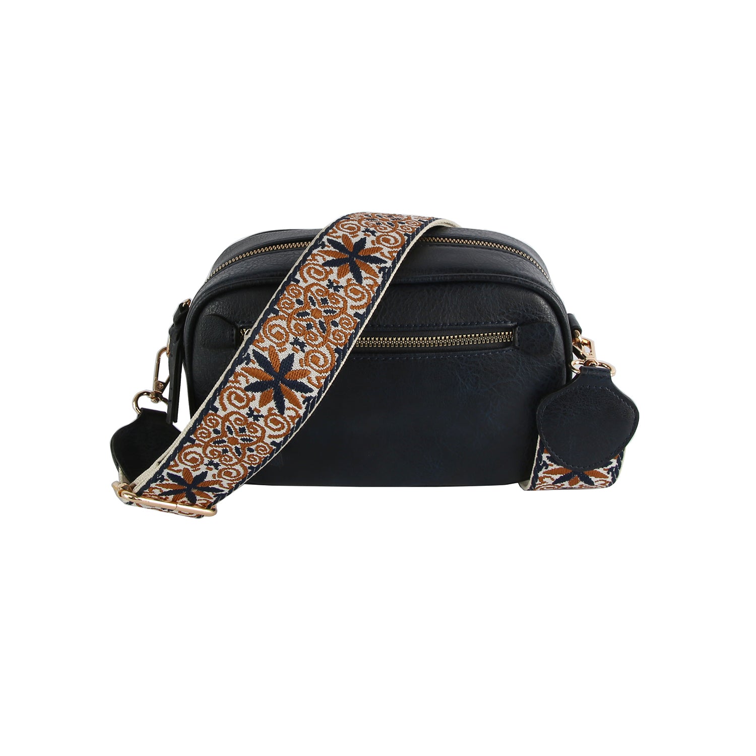 The Guitar Strap Crossbody Sling is a black faux leather bag with gold-toned hardware, a front zipper pocket, and a wide adjustable strap with an intricate brown, tan, and black floral pattern.