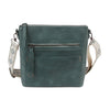 The Guitar Strap Everyday Crossbody Sling is a teal faux leather bag with a front zip pocket, card slots, and a wide patterned adjustable strap, shown against a white background.