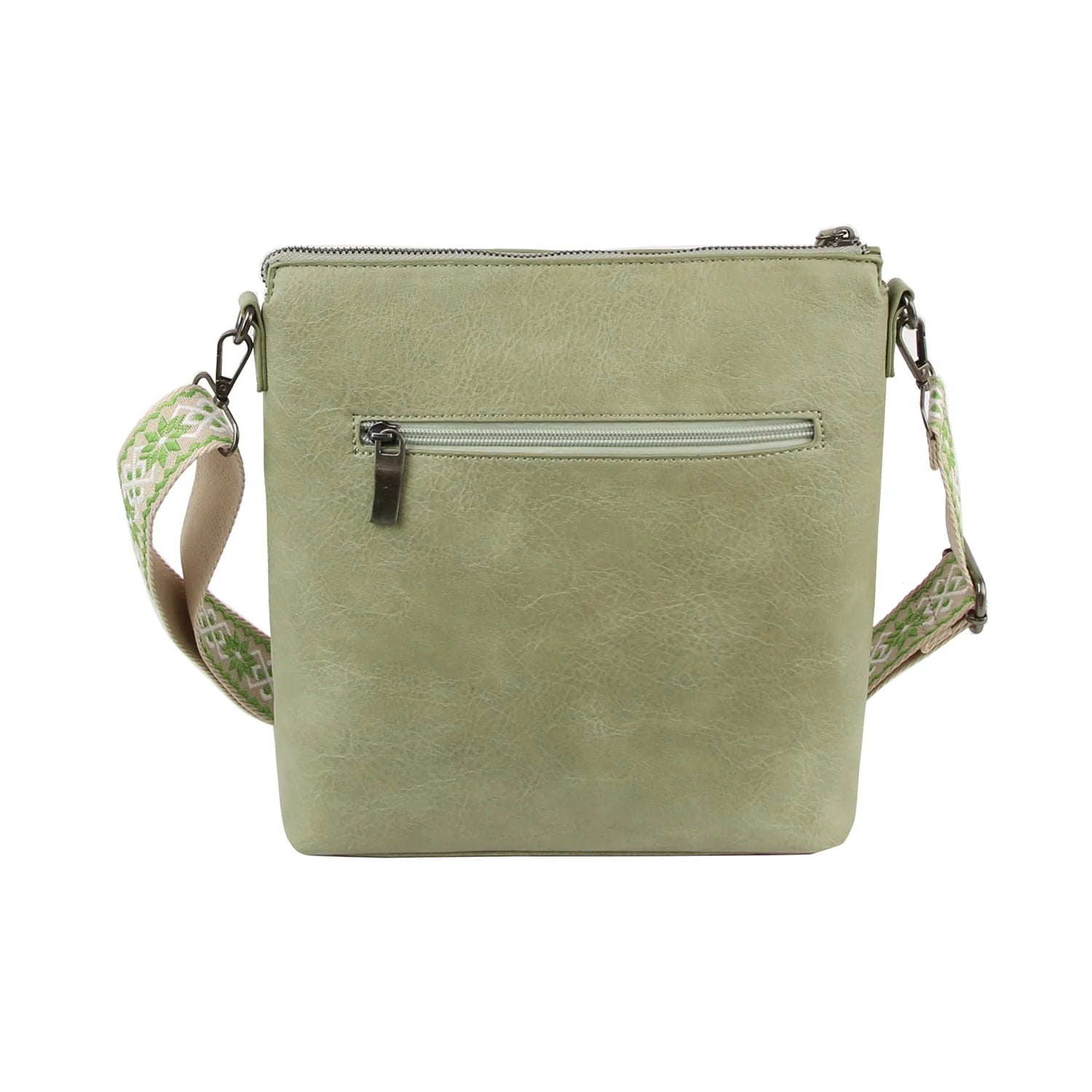 The Guitar Strap Everyday Crossbody Sling is a light green faux leather bag with a textured surface, zip pockets—including a back pocket—and a wide, patterned adjustable strap, shown against a plain white background.