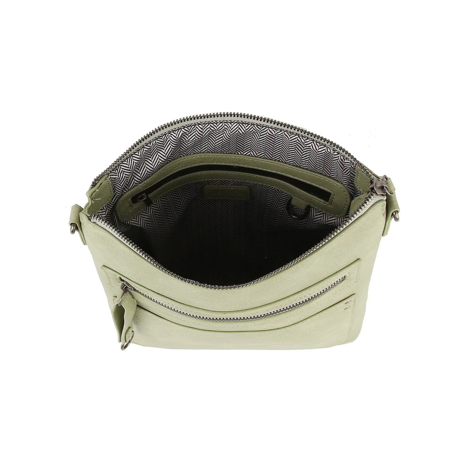 The Guitar Strap Everyday Crossbody Sling is a small, light green faux leather bag with an open main compartment, revealing a black and white chevron-patterned lining, an inner pocket, and convenient zip pockets including an exterior one.