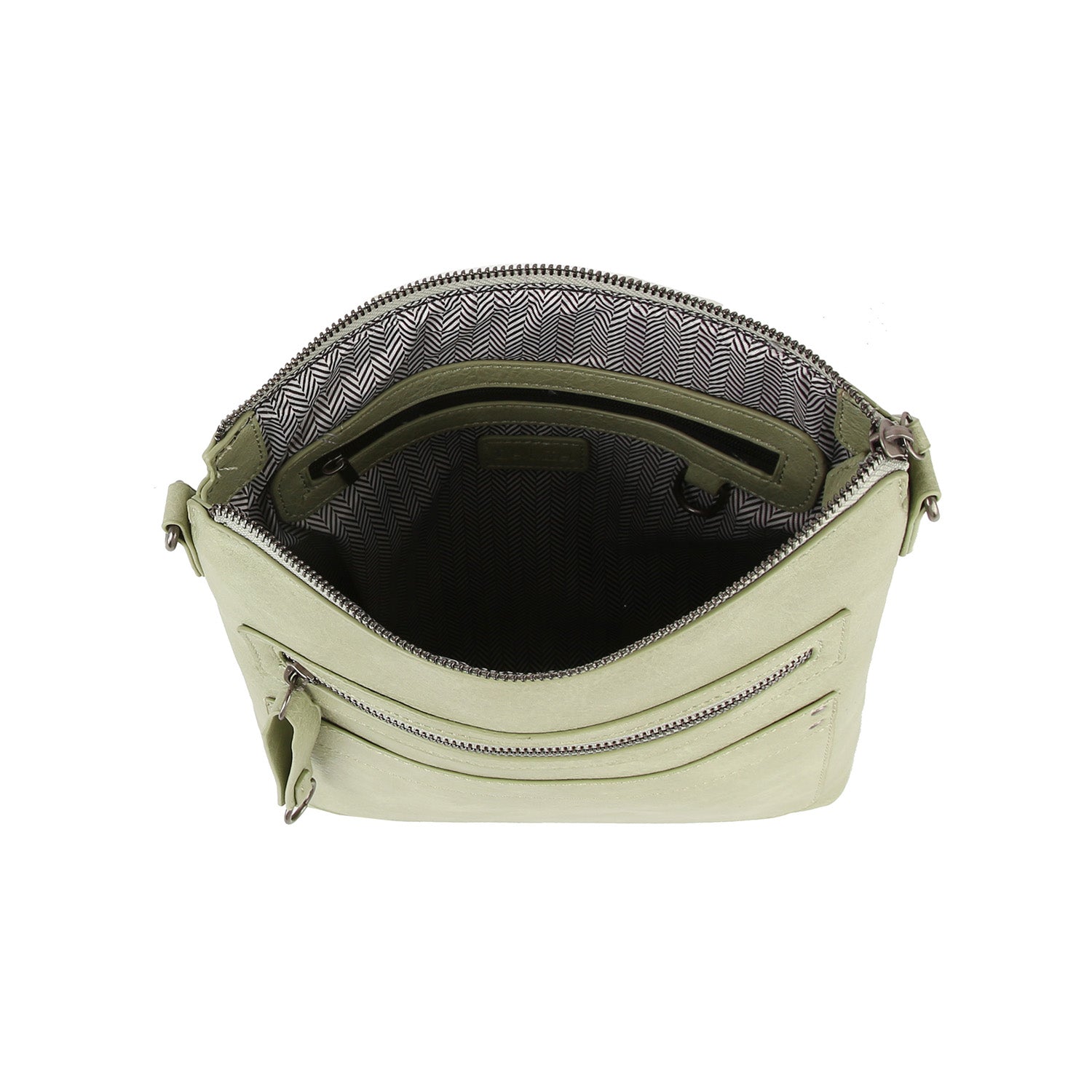 The Daily Zip Pocket Guitar Strap Crossbody Bag is a light green faux leather handbag with silver tone hardware, zipper closure, front zip pocket, black-and-white herringbone lining, and a crossbody guitar strap for versatile wear.