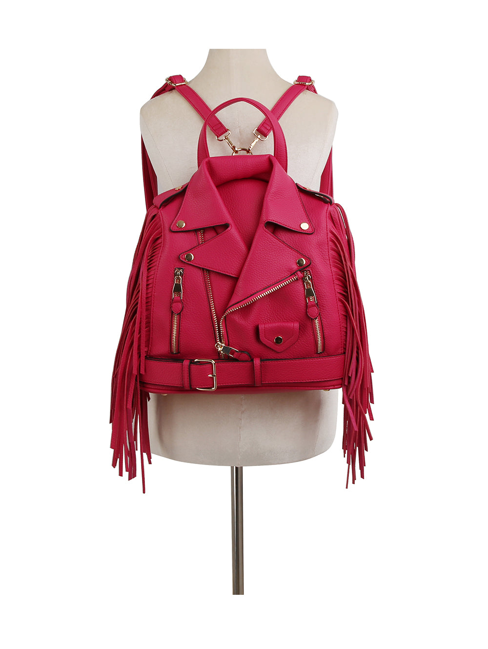 The Fringe Motorcycle Jacket Backpack is a hot pink faux leather bag with zipper accents, gold hardware, adjustable straps, and long side fringe, styled to look like a biker jacket and displayed on a dress form mannequin.