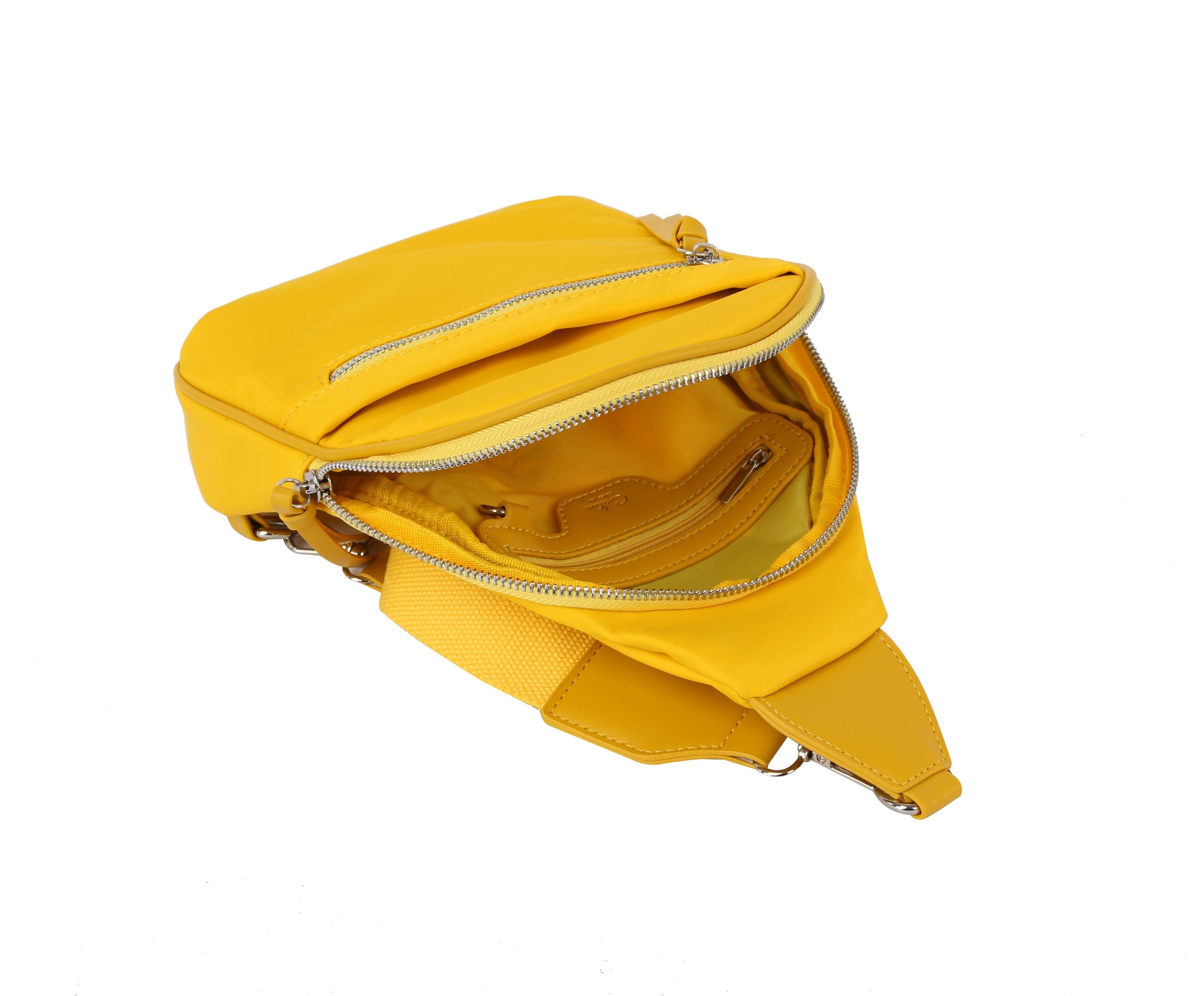 The Trendy Front Crossbody Sling is a small yellow faux leather bag with a main zip compartment, inner zip and slip pockets, adjustable shoulder strap, and silver hardware.