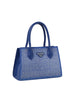 The Dazzling Rhinestone Accented Hand Tote is a blue faux leather handbag with two handles, a structured rectangular shape, rhinestones on the front and sides, and a small triangular metal logo plate.