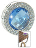 The Gem and Rhinestone Purse Hanger is a round, silver accessory with a faceted blue gem center and rhinestones around it, shown holding a handbag from the table edge.