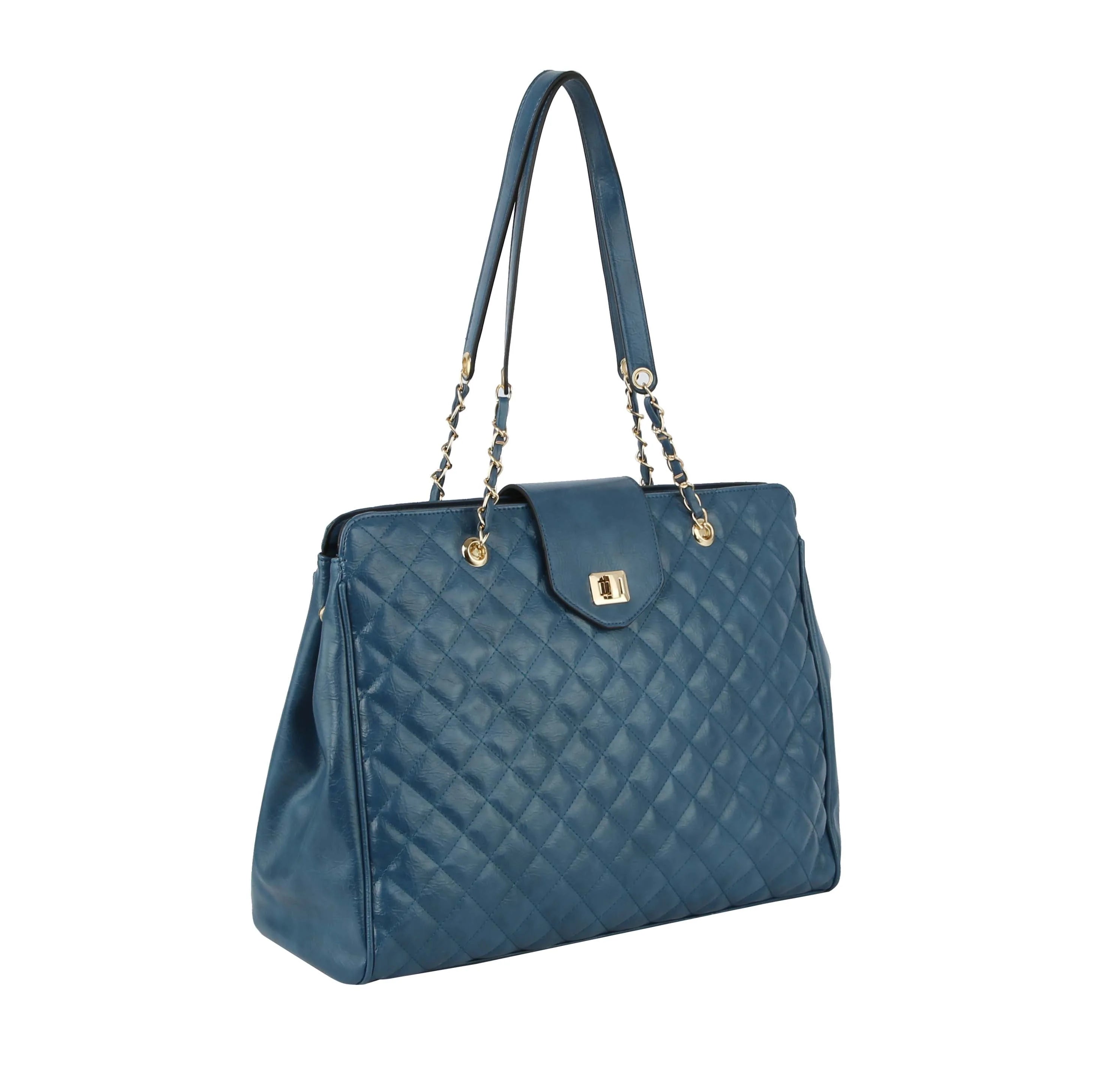 The Oversized Quilted Tote Travel Bag features blue faux leather, gold hardware, double chain and leather shoulder straps, and a flap closure. Shown on a white background.