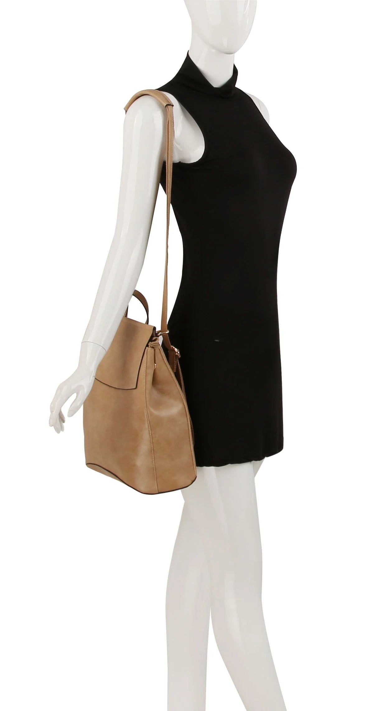 A mannequin in a sleeveless black dress showcases the Convertible Classic Fashion Backpack, a large tan faux leather bag with a long strap worn over the left shoulder at hip level. The bag is tablet compatible. The background is white.