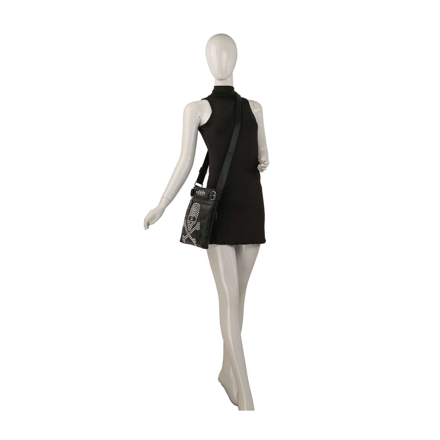 A mannequin in a sleeveless black mini dress is shown from the back, carrying the Spectacular Skull Design Crossbody Sling featuring bold white graphic designs.