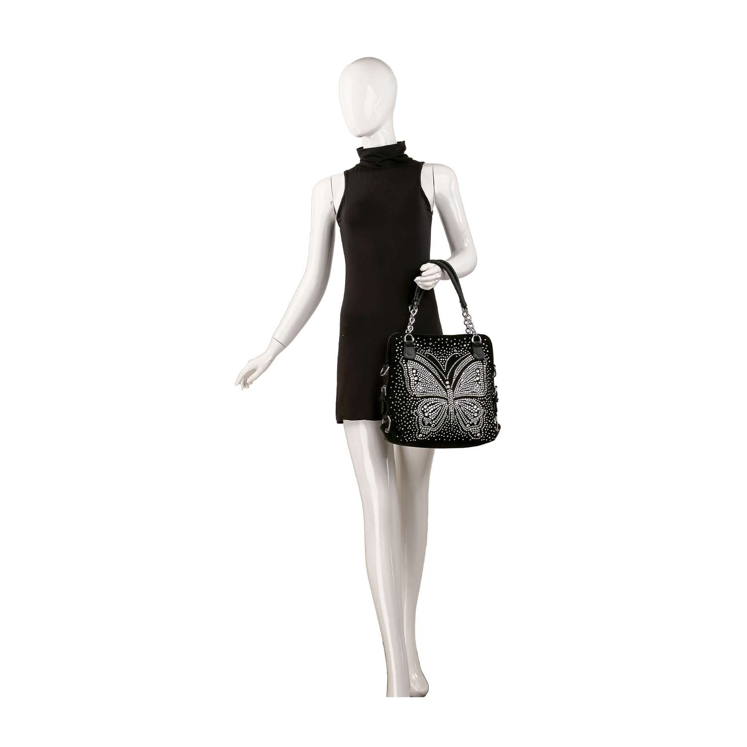 A mannequin in a sleeveless black dress holds the Dazzling Rhinestone Butterfly Shoulder Bag, a large faux leather accessory adorned with ornate silver butterfly details, set against a clean white background.
