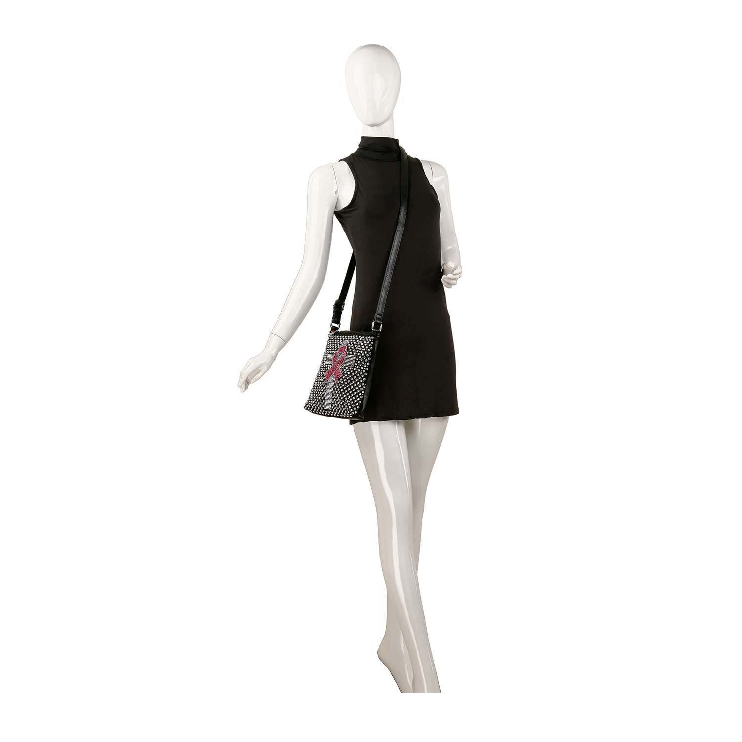 A mannequin poses against a plain white background in a sleeveless black mini dress, accessorized with the Rhinestone Bling Breast Cancer Crossbody Sling, which features a colorful design and faux leather material.